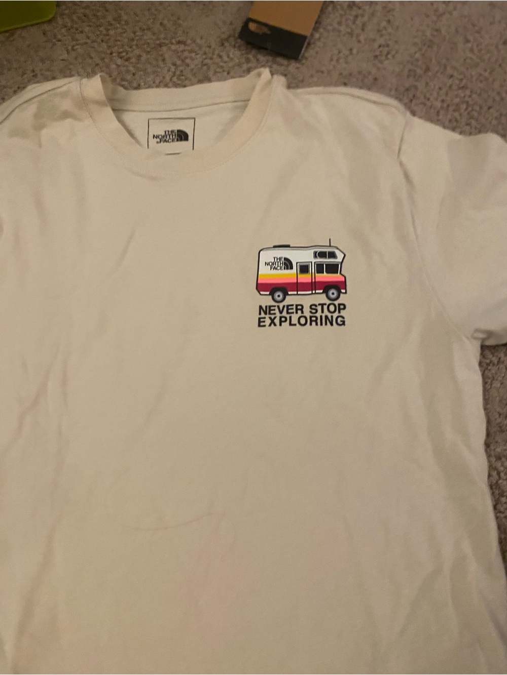 The North Face men’s small Never Stop Exploring" Cream Graphic Tee